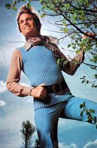 Happy man in blue sweater vest with belt.