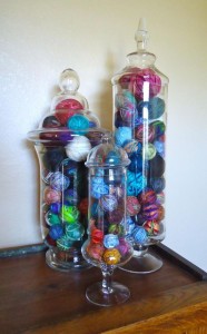 Scrap yarn balled up and stored in glass jars.